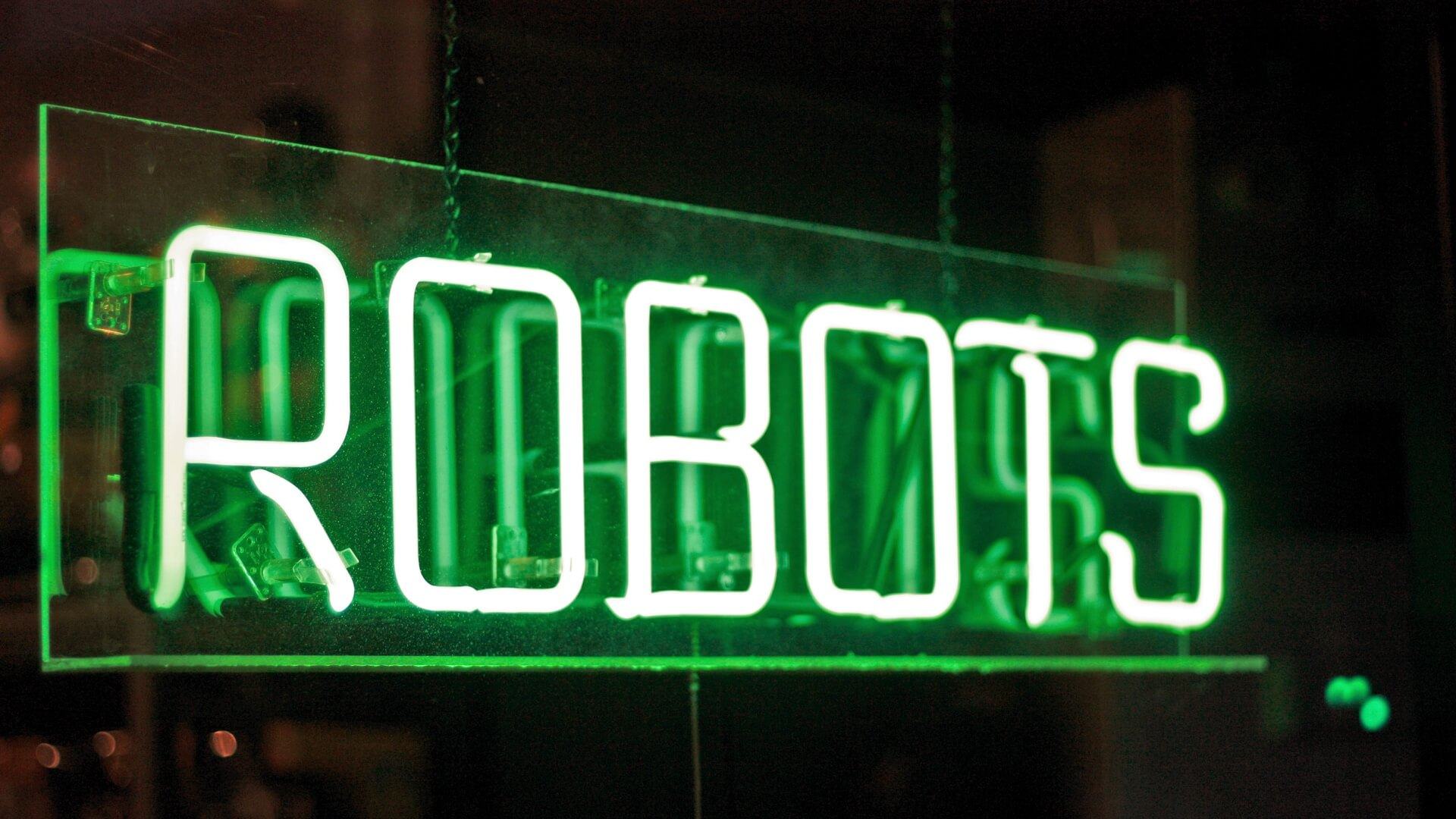 Letreiro brilhante escrito Robots.