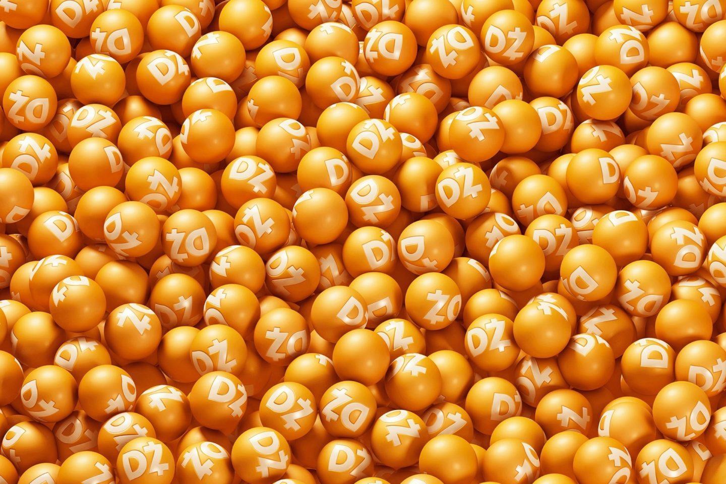 Um monte de bolinhas laranjas com o símbolo da Dotz amontoadas na tela..