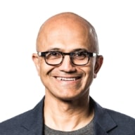 Bald man wearing glasses, smiling.