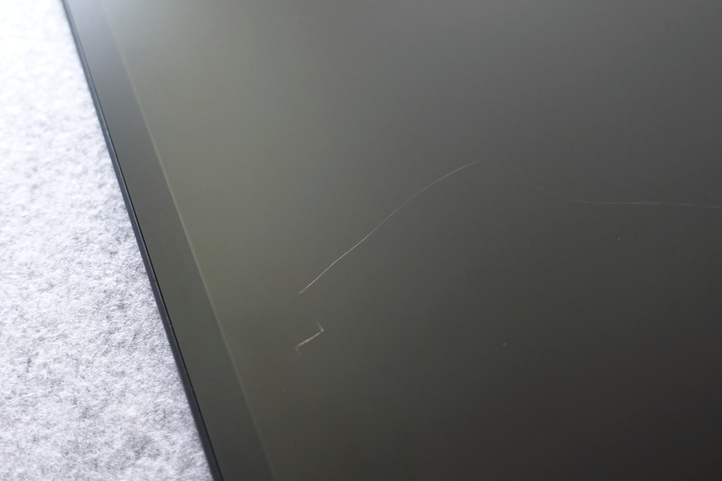 Detail of a large risk on the TCL tablet screen turned off.
