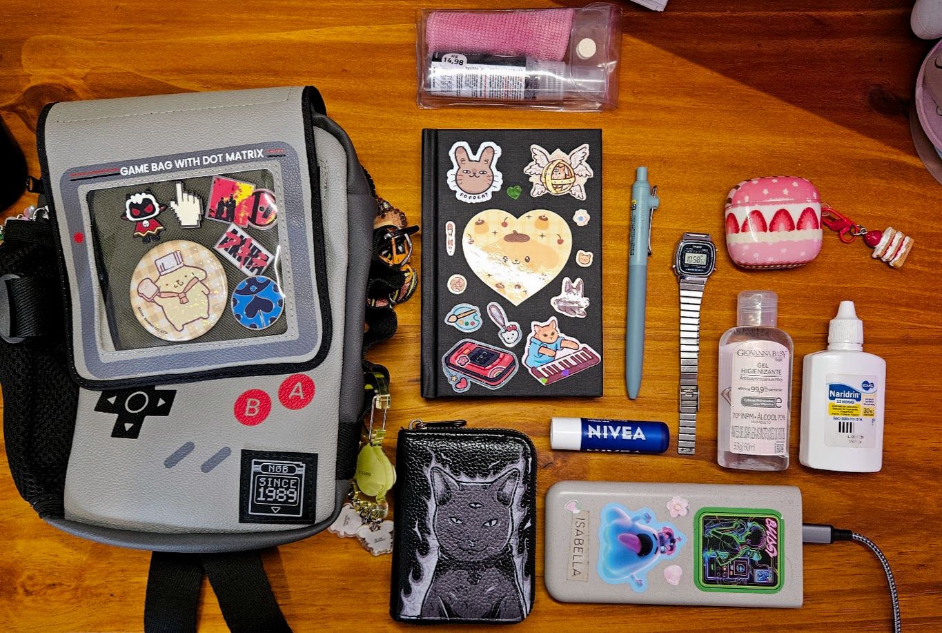 Overhead photo of Isabella's bag and all the items she carries laid out on a table.